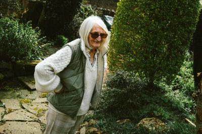 Lady wearing sunglasses in a garden.