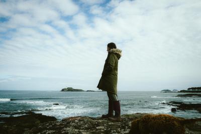 Person on shoreline looking out to sea.