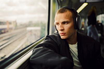 Man looking out of the window on a train.