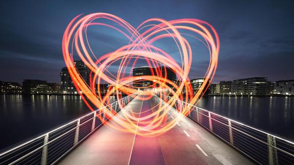 Large heart drawn with light on a bridge connecting the two sides of the harbor. Love for the city we live in. Love sign